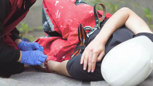 Photo of a trained workplace first aider responding to an on-site first aid emergency.